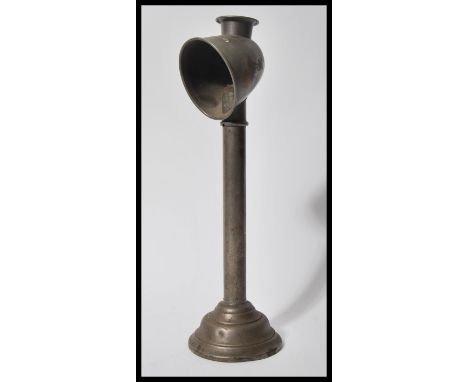 A vintage early 20th Century metal gas students lamp raised on stepped circular base with open conical shade.