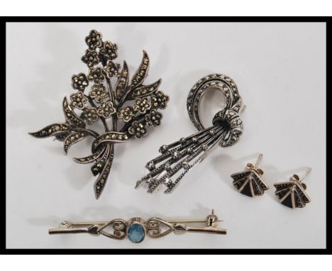 A collection of silver brooches together with a pair of Art Deco style silver earrings. The brooches being set with marcasite