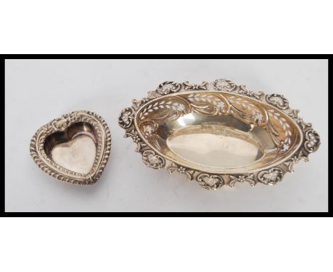 A silver hallmarked bon bon dish having scrolled decoration to the rim and pierced decoration to the bow, along with a heart 