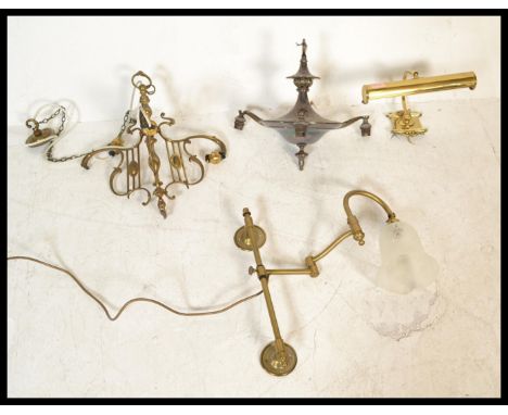 A group of vintage lighting to include a bankers lamp type wall light in brass, a silver plated multi branch candelabra, anot