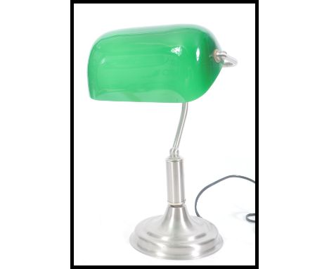 A vintage retro 20th Century bankers lamp having an adjustable green glass shade raised on stepped conical base. Measures 38 