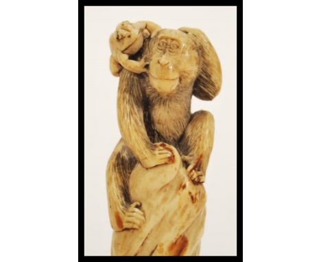 A 19th Century Japanese Meiji period hand carved Okimono type walking stick / parasol handle depicting a Monkey and Toad rais