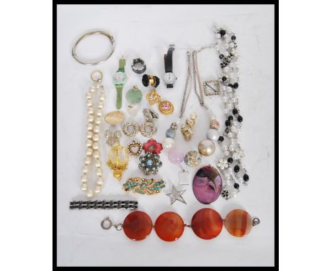 A collection of vintage costume jewellery to include a silver hinged bangle, a bracelet of four faceted agate stones, simulat