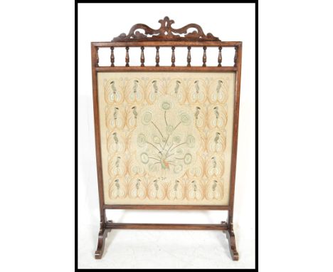 A 19th Century framed fire screen guard having a fantastic hand embroidered silk panel depicting a peacock among other birds 