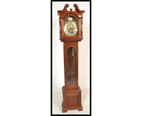 A 20th Century long case clock marked for John Coombs of Weston Super Mare having a white chapter ring with roman numerals an