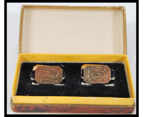 A pair of early 20th Century hallmarked 9ct gold Art Deco gents cufflinks of octagonal form having engine turned grid design.