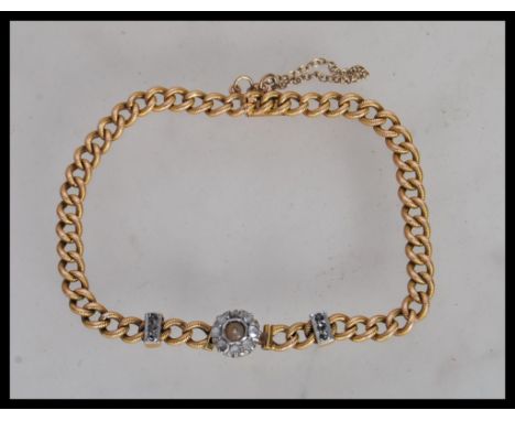 A 19th Century Victorian 18ct gold bracelet having a curb link chain with a central halo of old cut diamonds and a tongue and