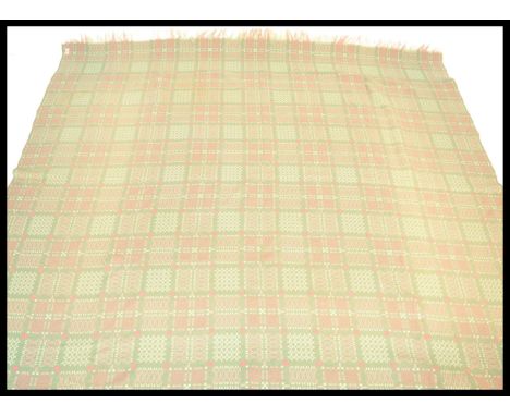 A vintage 20th Century Welsh woolen blanket, on a light blue ground with geometric patterns throughout. Measures 234 cm high 