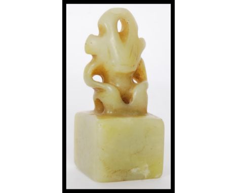 A 17th / 18th century Chinese celadon jade ink block seal of square form adorned with a seated Chimera atop. Carved from one 