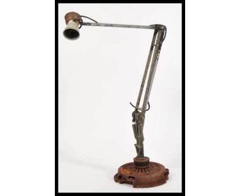 A vintage retro 20th Century Military Air Ministry anglepoise lamp by HT&amp;S raised on circular base.
