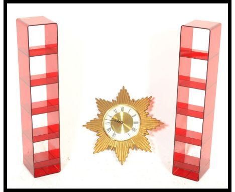 A pair of vintage retro 20th Century red acrylic display stands of rectangular form having five shelves and rounded corners a