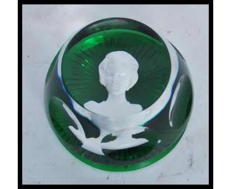 A vintage 20th Century Baccarat paperweight in green glass having a cameo portrait of a lady to center. Stamped and dated to 