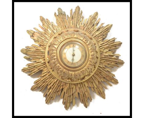 A vintage retro 20th Century Smiths sunburst / starburst wall clock having a central circular dial having a gilt wooden frame