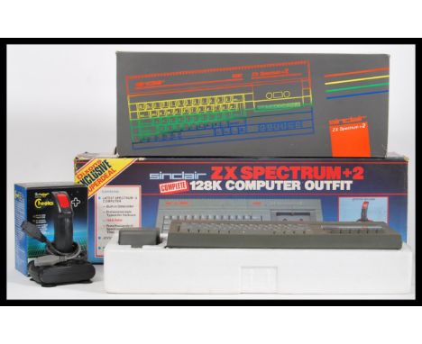 A vintage Sinclair ZX Spectrum +2 128k computer outfit games console in its original illustrated box.