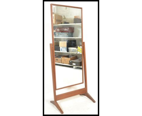 A vintage retro Teak wood cheval free standing full length mirror raised on a square supports terminating in sledge feet. Mea