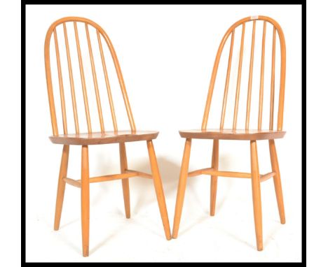 A pair of 20th Century Ercol Windsor style Priory Quaker hoop-back dining chairs in light elm. Measures 97 cm high x 44 cm wi