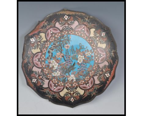 A late 19th Century Japanese Cloisonne charger plate of scalloped form having central blue enamel cartouche panel depicting f