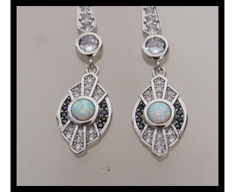 A pair of stamped 925 silver Art Deco style drop earrings set with cz accent stones, with opal cabochons flanked by two rows 