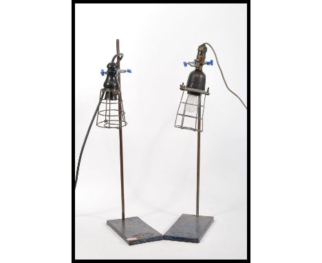 A pair of vintage retro 20th Century inspection lamps having wire cages mounted on Griffin and George laboratory stands.
