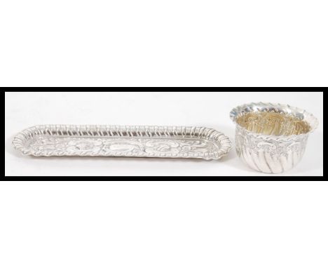 A silver hallmarked dressing table trinket tray having repousse scrolled and reeded decoration (hallmarked for Walker &amp; H