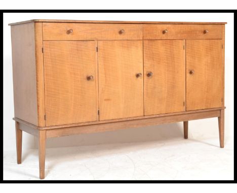 A vintage mid 20th Century Gordon Russell of Broadway walnut sideboard credenza, two long drawers over four doors raised on s