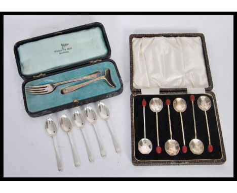 A silver hallmarked food pusher by Walker &amp; Hall along with a set of six silver hallmarked tea spoons by&nbsp;Josiah Will