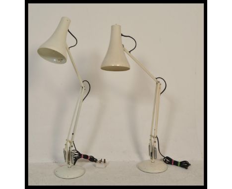 Two vintage retro Herbert Terry 20th Century anglepoise table desk lamps&nbsp; raised on circular bases with iconic conical p