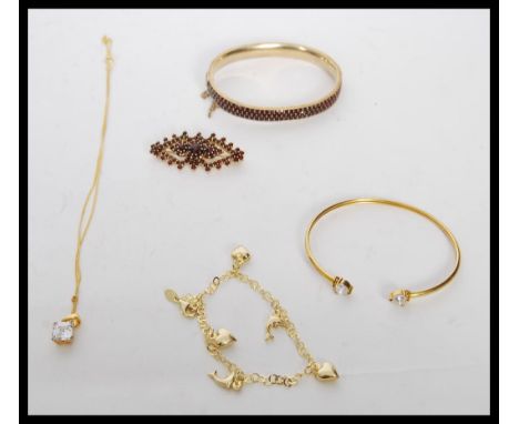 A selection of silver vermeil jewellery to include stamped 925 silver vermeil bangle bracelet set with two white stones, a st