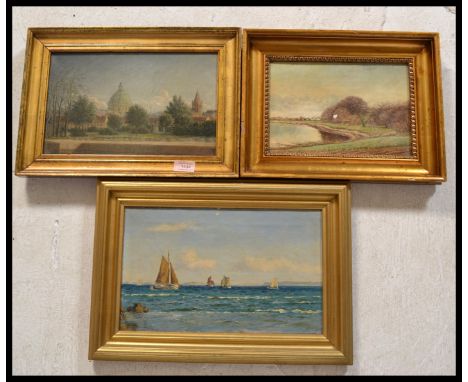 A group of three 20th Century oil on board paintings of different vistas to include a seascape with boats at full mast, a vie