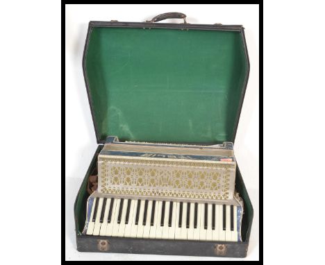 A vintage retro 20th Century large piano accordion by Itala having mother of pearl decoration with 120 buttons. Complete in c