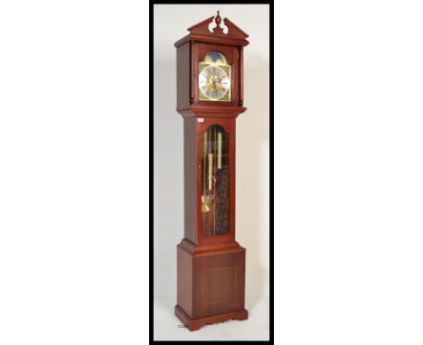 A 20th Century triple chime Westminster long case clock having a moon phase dial with roman numerals to the chapter ring and 