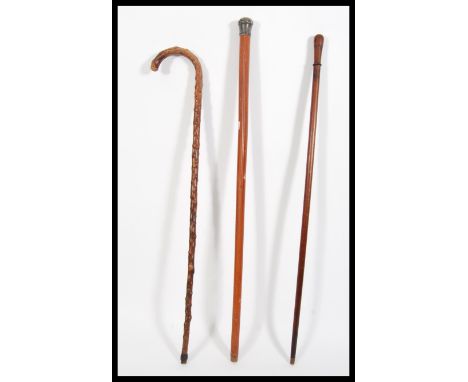 A group of three 19th / 20th Century walking stick canes to include a palmwood example, a hallmarked silver topped example an