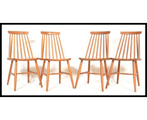 A set of four vintage retro 20th century Ercol style beech and elm Windsor dining chairs having stick backs with shaped back 