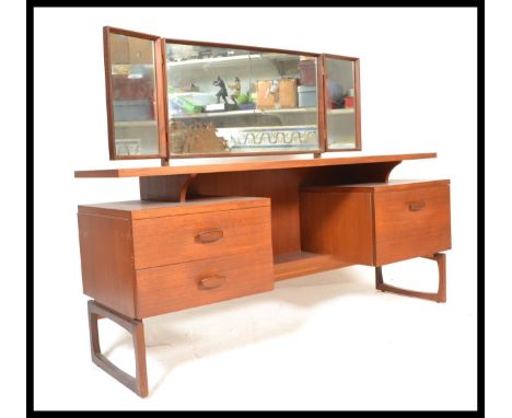 A vintage retro 20th Century teak wood Erst Gomme for G Plan dressing table, having an arrangement of drawers under adjustabl