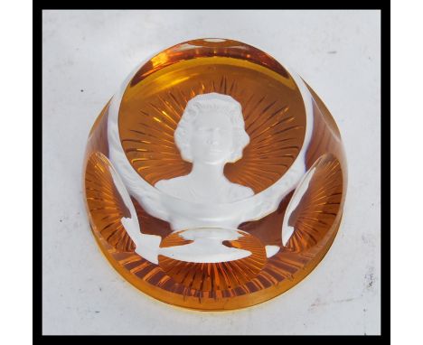 A vintage 20th Century Baccarat paperweight in amber glass having a cameo portrait of a lady to center. Stamped and dated to 
