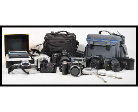 A collection of vintage cameras lenses and accessories to include Nikon, boxed Olympus camera, Nikon D70 with DX lens, Kodak 