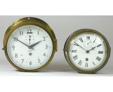 Two bulkhead clocks, to include a Smith's Empire, brass cased, white dial with Arabic numbers, with subsidiary seconds hand, 