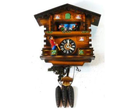 A German Black Forest cuckoo clock, circa 1960s, chalet style with musical carousel and a three train movement. 