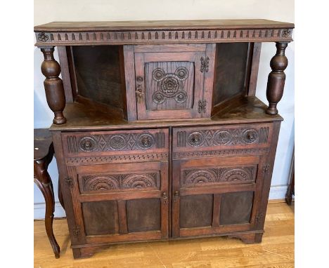A late 19th early 20th century buffet serving cabinet, having central cupboard to the top, two frieze drawers and two base cu