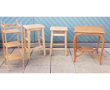 A pair of early 20th century stripped pine kitchen stools, 60cm tall, together with a pine three tier wotnot, 84cm tall,  and