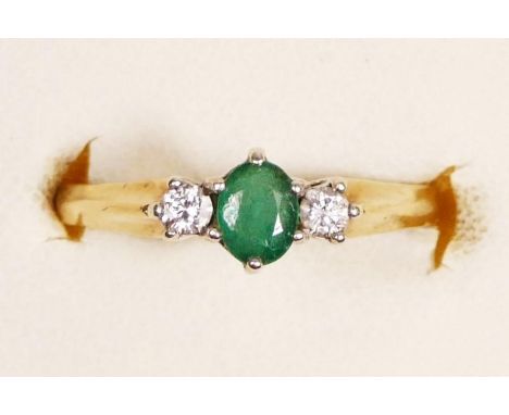 A 9ct gold emerald and brilliant cut diamond three stone ring, k 1/2, 2.1gm 