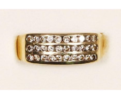 A gold and brilliant cut diamond three row channel set ring, tests as 9ct gold, J, 2.6gm 