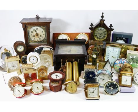 A collection of manual wind and quartz movement mantel clocks, traveling alarm clocks and miniature novelty clocks. (4) 