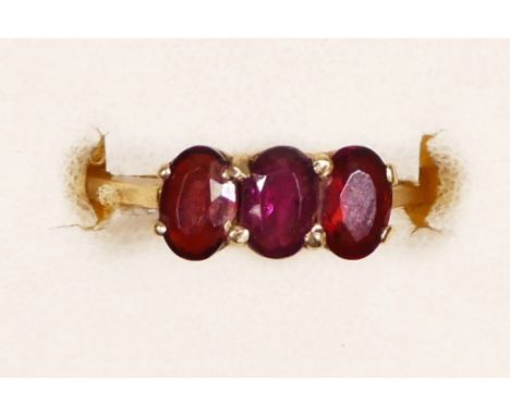 A 9ct gold three stone garnet ring, L 1/2, 1.8gm