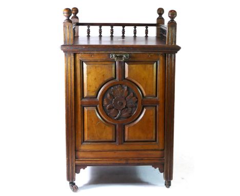 An Edwardian mahogany coal scuttle having turned carved gallery back over top with chamfered edge and lift down panelled door