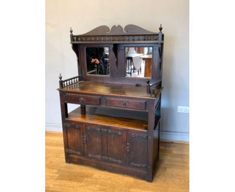 An Early primitive oak court cupboard, having galleried mirror backed shaped panel, over two frieze drawers with two cupboard