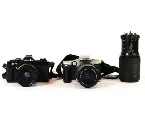 A Minolta X-7 film camera, with a 35mm-70mm lens, a Minolta Dynaxx 4, with a 100mm-300mm lens and a 75mm-200mm lens 