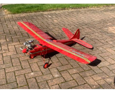 A radio controlled model plane with a MDS 40 engine, removable wings open to reveal servos decorated with applied badges, 130