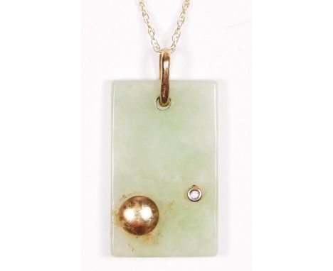 A 9ct gold mounted jade panel pendant, 30 x 18mm, diamond set, 9ct gold chain. 