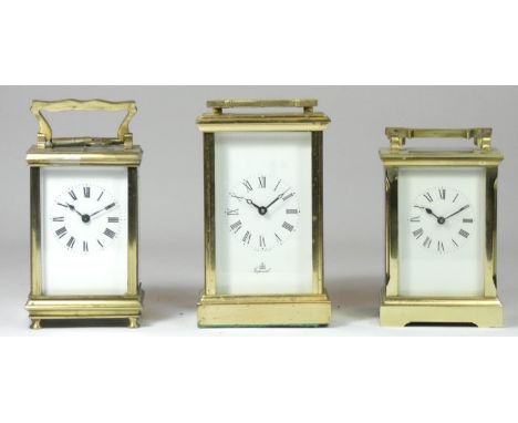 A brass case carriage clock, by Imperial of England, four bevelled glass sides with balance wheel window, white dial with pai